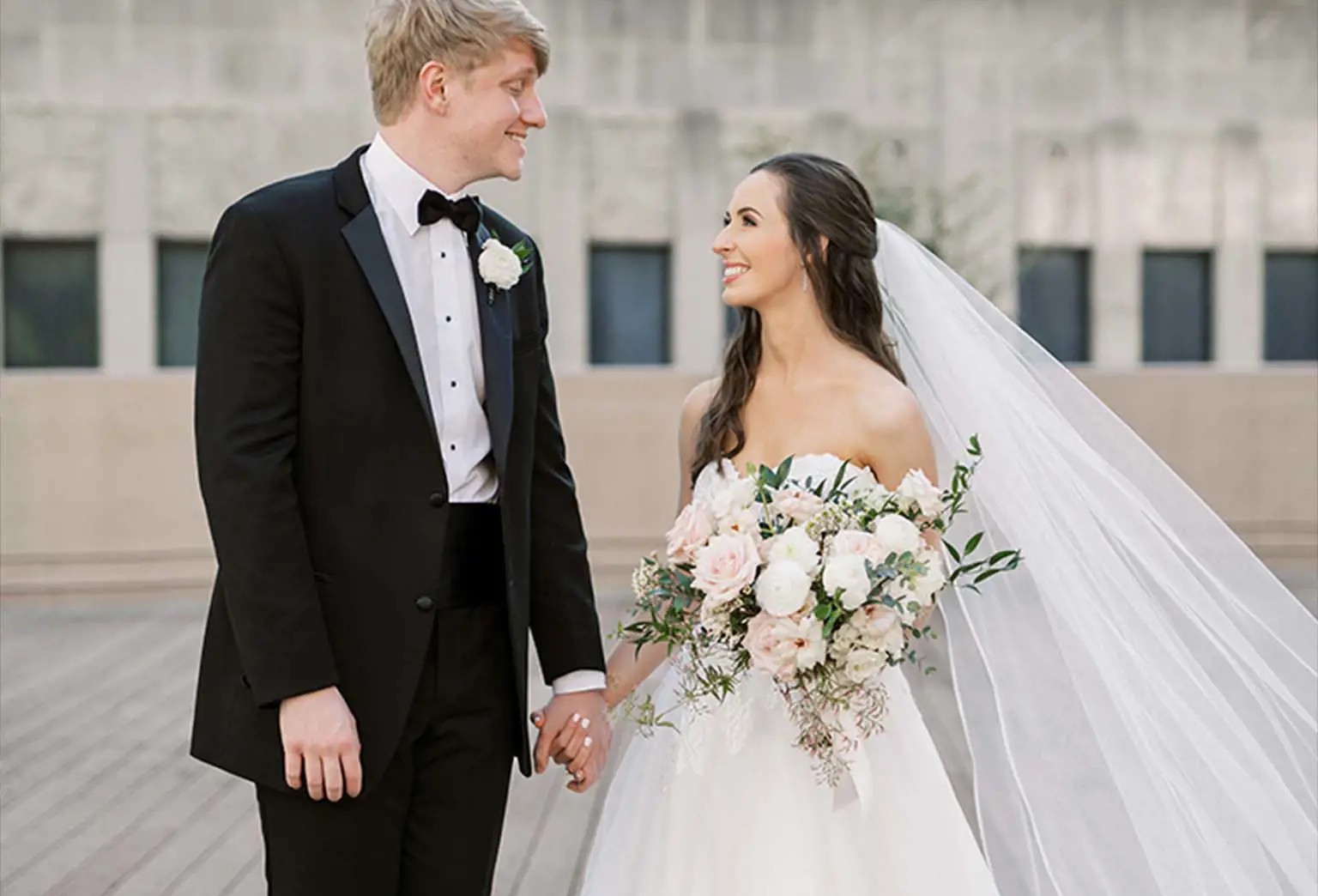 Сouple wearing a white gown and a black suit